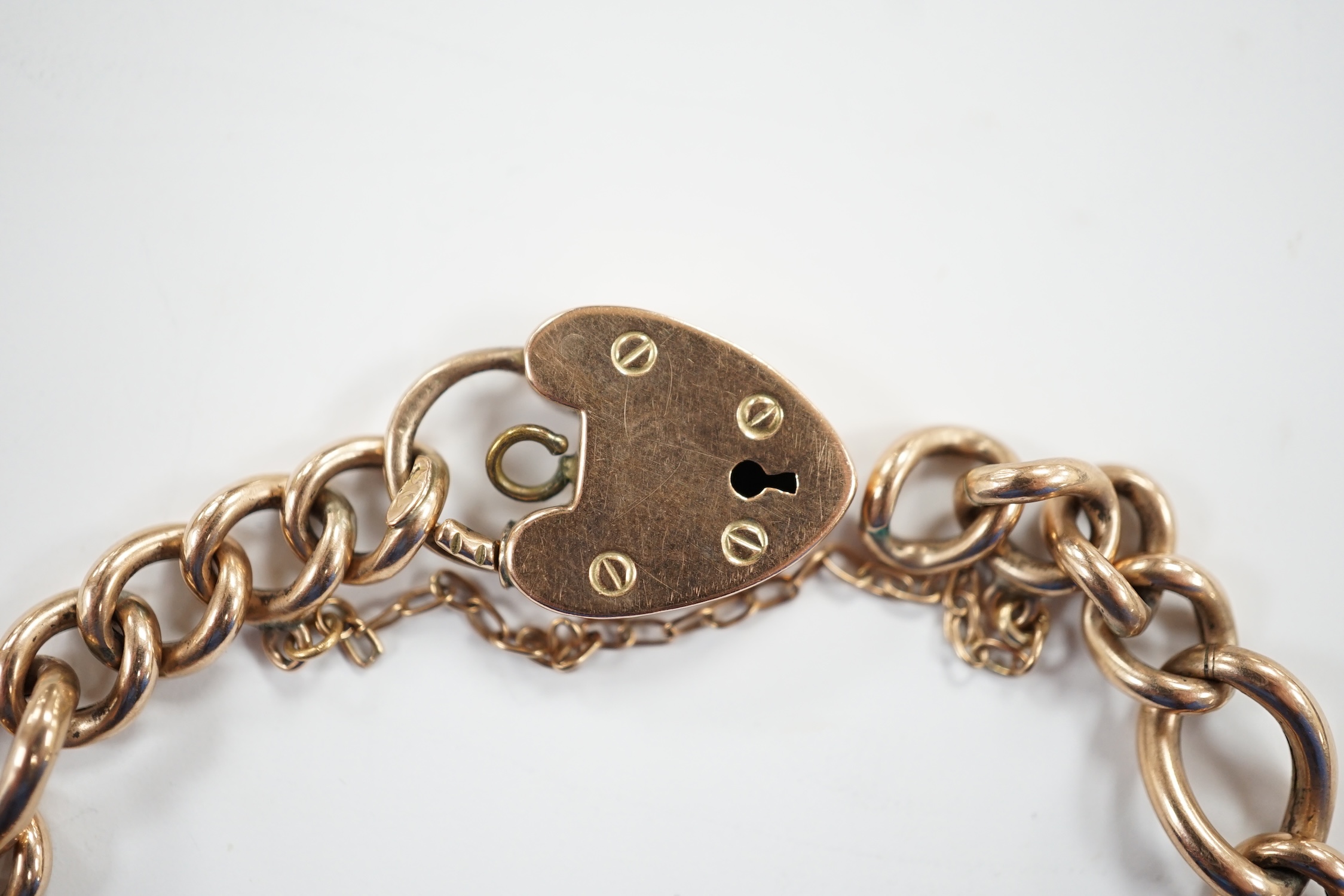 A 9ct gold and turquoise bead set curb link bracelet, with heart shape padlock clasp, 18cm, gross weight 11.2 grams.